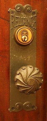 late 19th century american ornamental cast iron reliance building interior passage door backplate with protruding collar or thimble