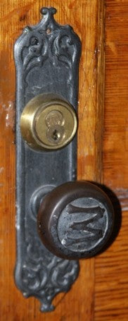 original late 19th century baked black enameled ornamental cast iron monadnock building interior office door backplate