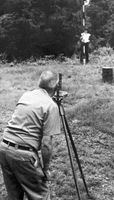 set of three identical depression era american industrial weathered and worn land surveying range poles with alternating white and red painted stripes