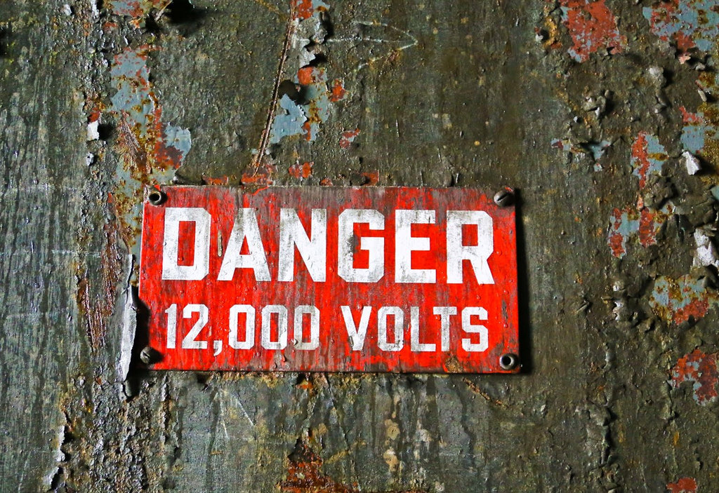 original late 1930's antique american single-sided cherry red porcelain enameled "12,000 volts" danger sign salvaged from the a. finkl foundry undergoing demolition
