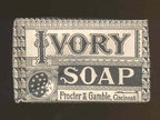 one of two identical antique american art deco wall-mount ivory soap glass dispensers with functional plunger