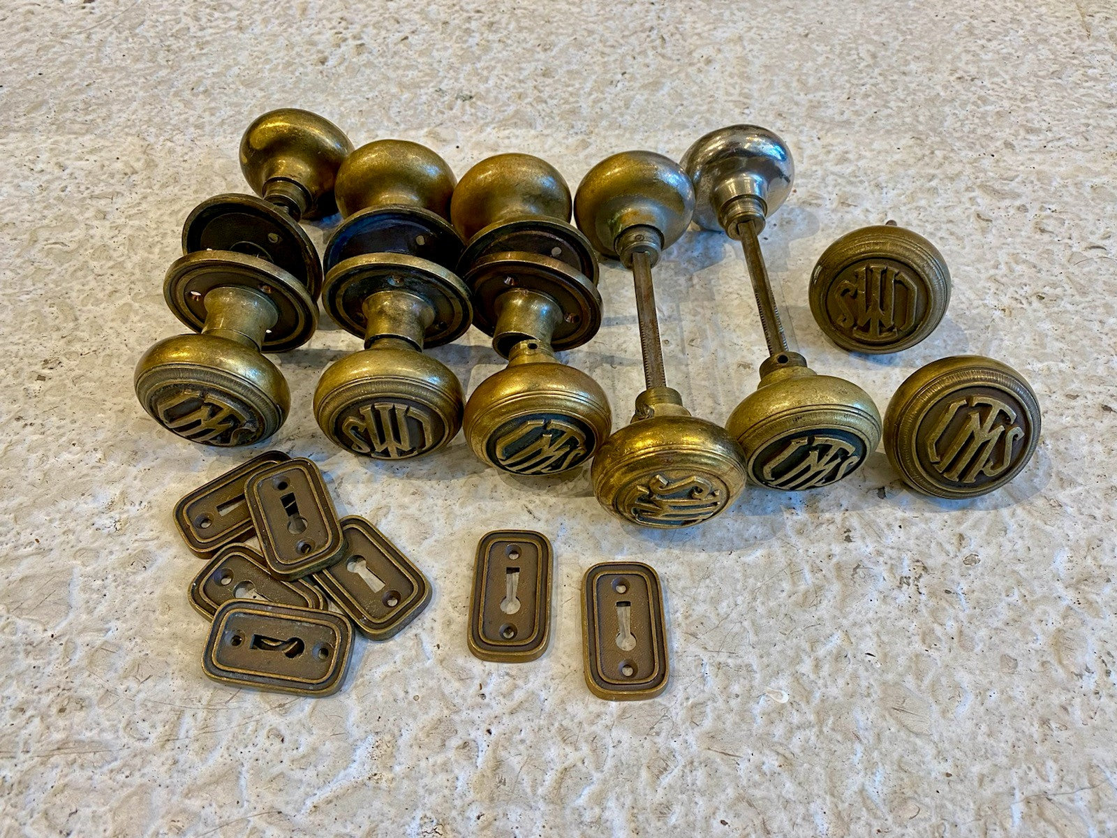 group of original early 20th century masonic temple cast brass doorknobs with rosettes and keyplates
