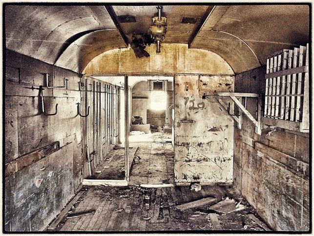 custom-built antique american industrial reinforced heavy gauge angled iron workbench or desk with newly added tabletop comprised of recycled railroad boxcar floorboards