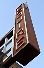 historically important gargantuan electrically animated exteiror chicago esquire theater building facade vertical neon sign