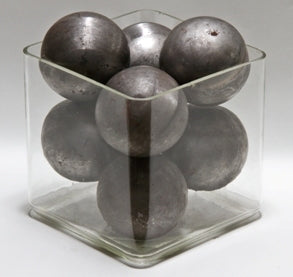 vintage industrial hollow steel "ornamental" spheres contained within old pyrex glass laboratory container