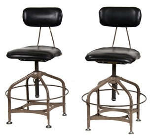 pair of c. 1950's black upholstered toledo laboratory stools with large heel rings