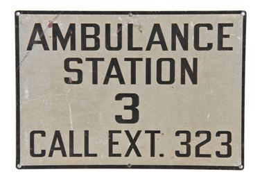 unusual c. 1930's single-sided "ambulance station" die cut steel wall mount sign