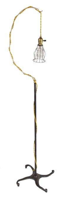 fully functional repurposed vintage industrial freestanding "trouble light" reading and/or floor lamp with uniquely designed cast iron four-legged brushed metal base