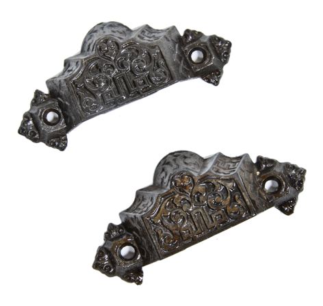 two matching original late 19th century antique american ornamental cast iron residential pantry drawer or bin pulls