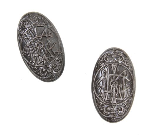 two matching elaborately designed late 19th century ornamental cast iron oval-shaped monogrammed doorknobs