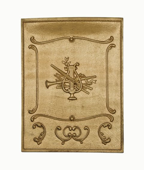 unusual late 19th century metallic gold enameled ornamental cast iron fireplace summer cover with an assemblage of musical instruments in deep relief