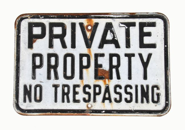 original late 1930's vintage industrial single-sided "no trespassing" die cut steel warning sign with deeply embossed lettering