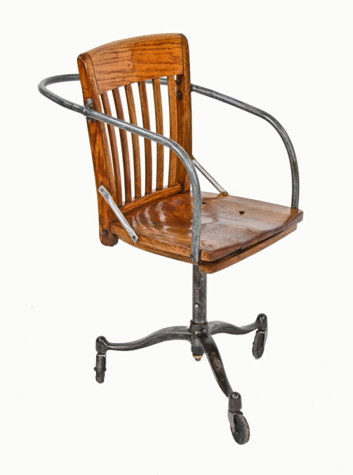 very unusual c. 1940's hastily assembled factory office "armchair" containing a three-legged cast iron base with large swivel casters