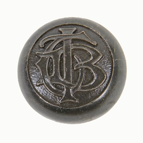original early 20th century interior american office building monogrammed cast iron doorknob in low-relief