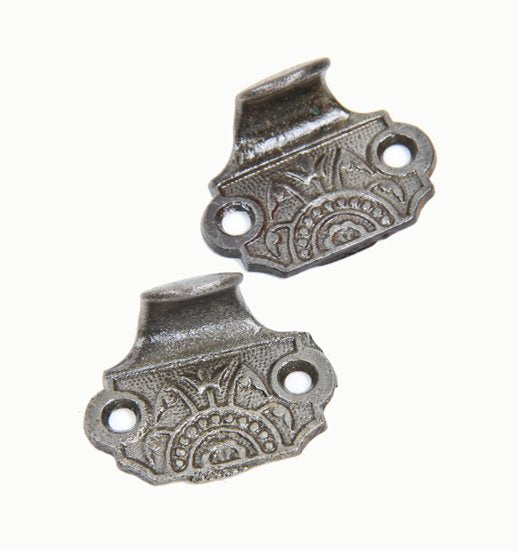 two matching 19th century american victorian era ornamental cast iron residential window sash pulls or finger lifts