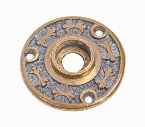 late 19th century antique american interior residential ornamental cast brass doorknob rosette with raised floral motifs