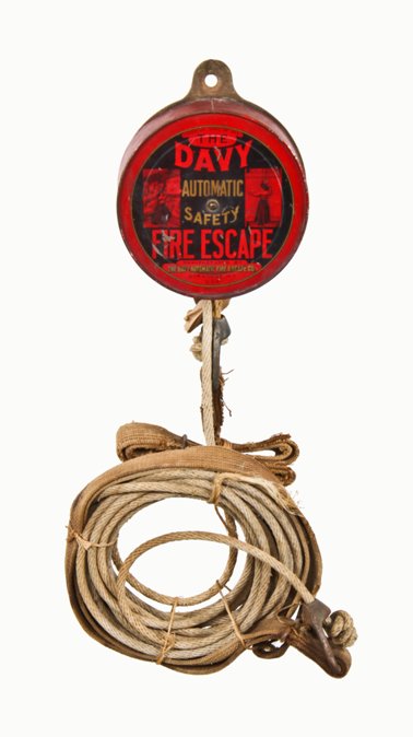 largely intact early 20th century american commercial building wall-mount "davy" fire escape device with original lithographed steel canister