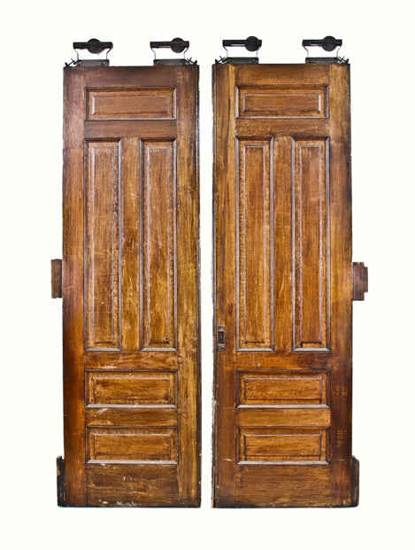 massive 19th century interior graystone varnished oak wood pocket or parlor doors with original cast iron hangers