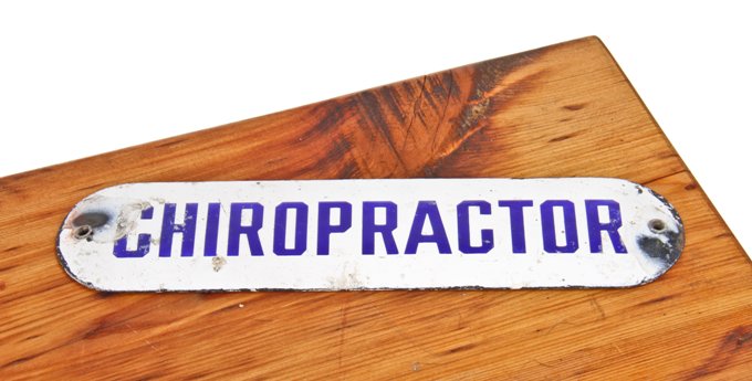 original and largely intact late 1920's american single-sided porcelain enameled "chiropractor" office door sign
