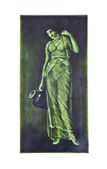 visually striking early 20th century majolica green glazed victorian era portrait tile featuring a full-figure costumed woman with vessel