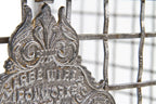 original late 19th century interior three-sided crimped steel square mesh bank teller cage with ornamental cast iron plaque