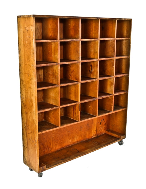 structurally sound and solid vintage american industrial pine wood steamfitter cubby hole cabinet with cast iron swivel casters