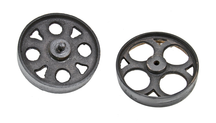 two distinct early 20th century american industrial reinforced cast iron spoked furniture factory cart wheels or casters with uniform black enameled finish