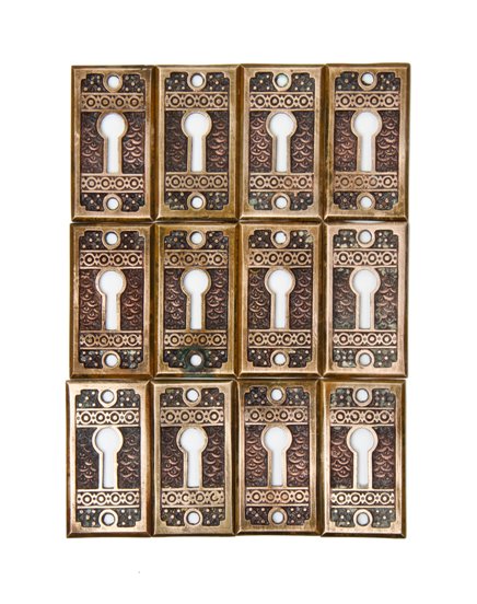 twelve matching antique american c. 1880's "brocade" pattern ornamental cast bronze interior residential keyhole escutcheons