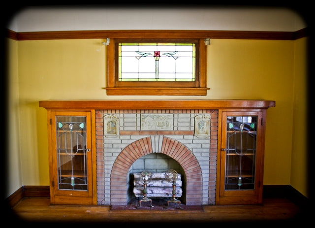 all original late 1920's american craftsman style interior residential bookcase fireplace mantel with leaded art glass cabinet doors
