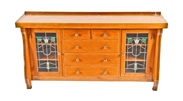 late 1920's american craftsman style interior residential varnished oak wood china cabinet or sideboard with art glass doors