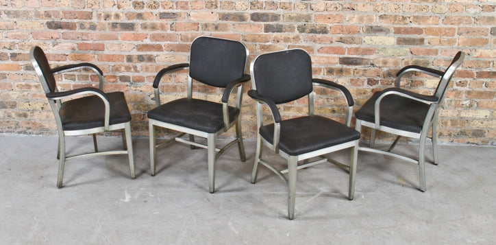 four matching c. 1940's vintage industrial brushed aluminum factory office armchairs with original black upholstered seats and backrests