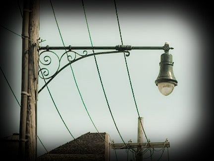 largely intact 20th century american industrial exterior city street lamp bracket with spun aluminum reflector