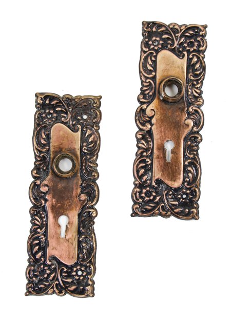 pair of original late 19th century late victorian era stamped bronze metal "eulia" pattern doorknob backplates