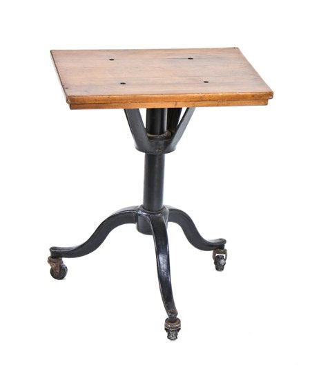 all original and completely intact early 20th century three-legged revolving gambling device or typewriter table with functional casters