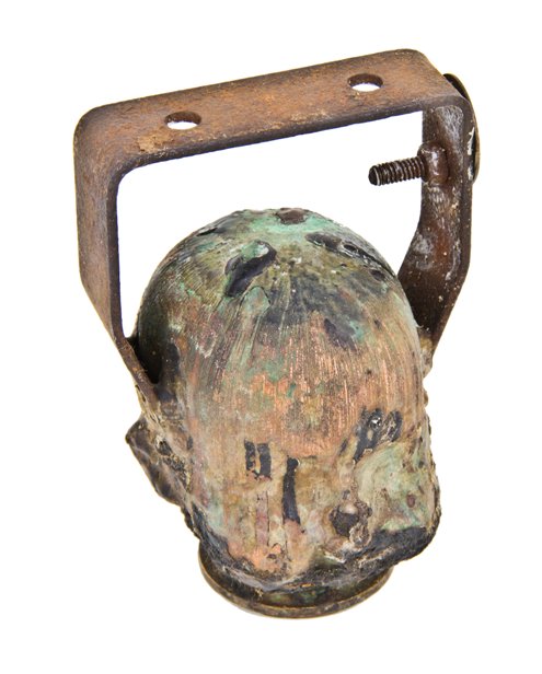 heavily coated vintage american industrial hollow copper doll head mold or form with stationary bent steel mounting bracket