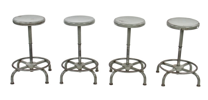 group of four matching fully functional gunship gray enameled adjustable height factory assembly plant swivel seat stools with telescoping movement