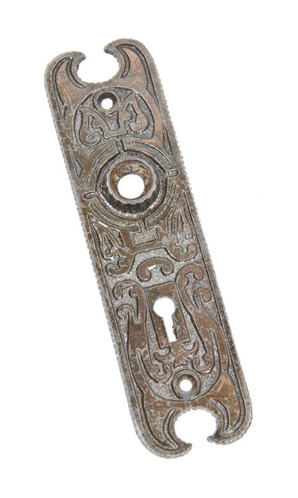uniquely shaped late 19th century ornamental cast iron interior residential doorknob backplate with worn copper-plated finish