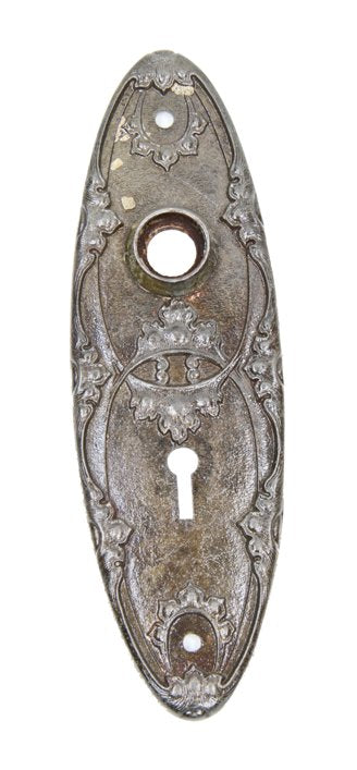 original early 20th century ornamental cast iron oval-shaped doorknob backplate with embossed intertwining leafage
