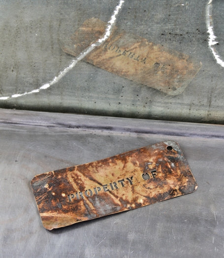 unique weathered and worn early 20th century vintage american industrial "property of" wrought brass template stencil plate