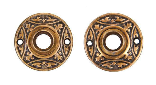 matching set of early 20th century stamped ornamental wrought brass passage door circular rosettes with black enameled inlay