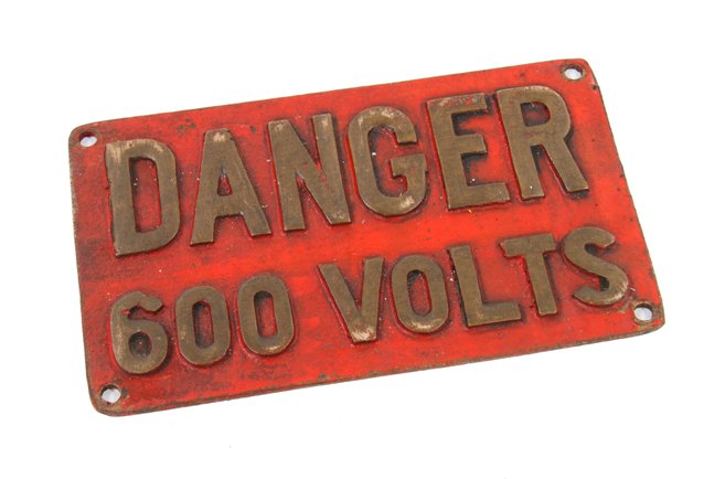 vintage american made industrial single-sided "600 volts" bronze metal railroad locomotive cautionary sign with red paint finish