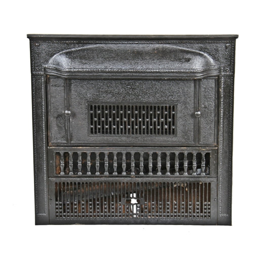 original and largely intact early 20th century black enameled ornamental cast iron fireplace gas insert with summer cover