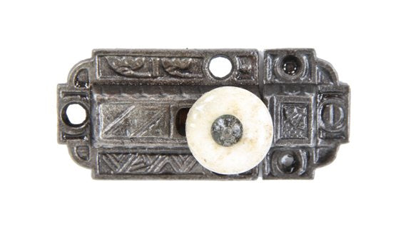 late 1870's antique american ornamental cast iron spring-loaded cabinet latch with intact white porcelain knob