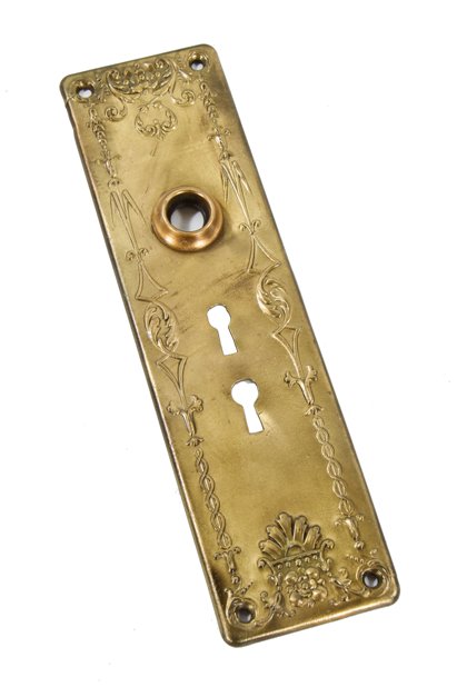 early 20th century american exterior residential stamped ornamental wrought brass doorknob backplate with double keyhole configuration