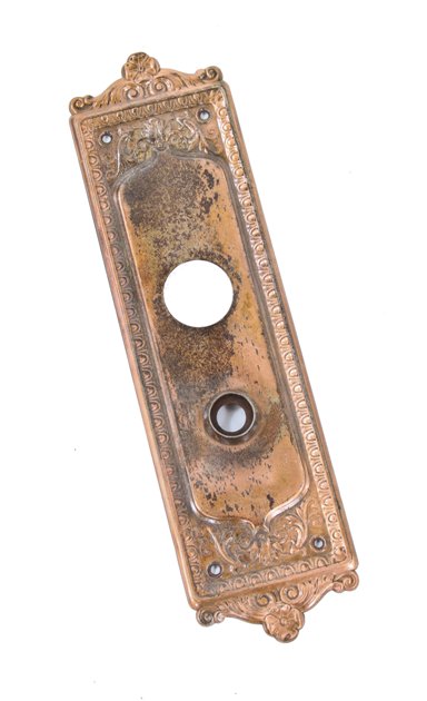 early american 20th century stamped ornamental steel "como" pattern exterior residential doorknob backplate with copper-plated finish