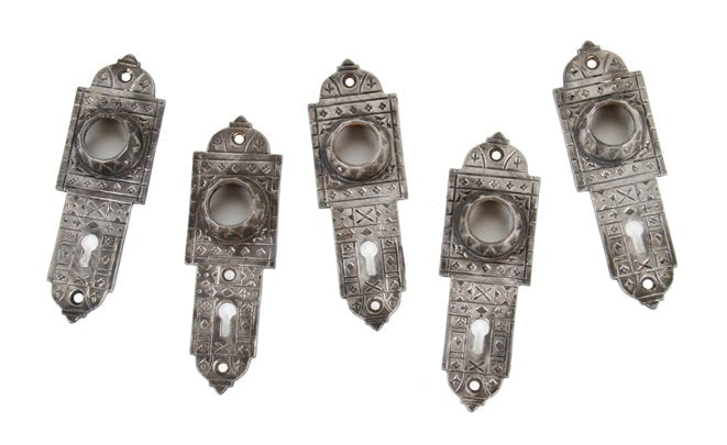 group of five matching original antique american decorative cast iron "screwless spindle" doorknob escutcheons or backplates