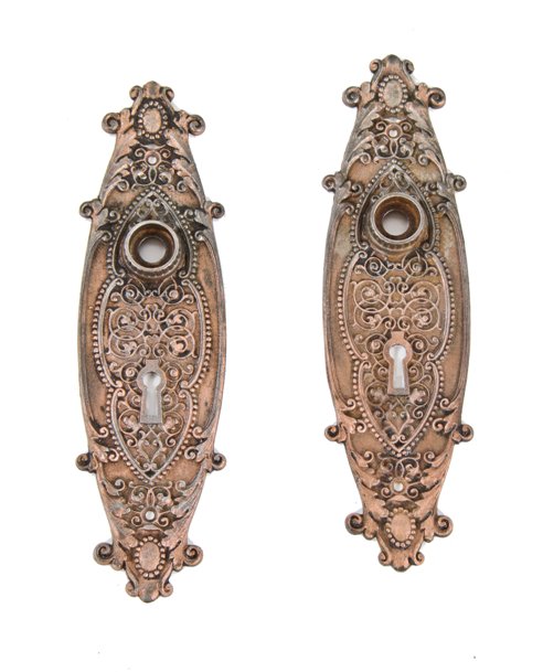 matching set of original antique american residential rococo style ornamental iron passage door backplates with copper-plated finish