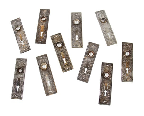 large lot of ten matching late 19th century american eastlake style "ceylon" pattern heavy wrought steel doorknob backplates