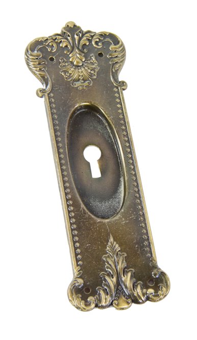 uniquely-shaped c. 1907 american neoclassical style stamped yellow brass residential pocket door backplate with darkened patina