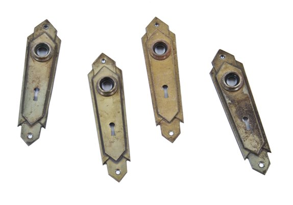 set of four matching c. 1920's american art deco "skyscraper style" interior residential stamped steel doorknob backplates